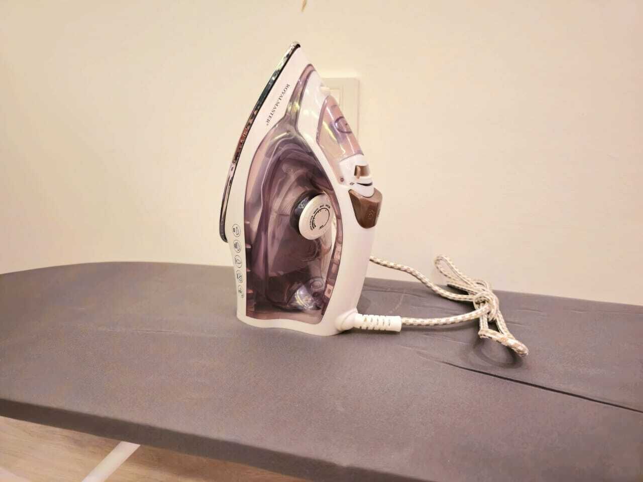 A portable iron on a flat surface.