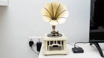 A desk with a vintage-style lamp, a computer monitor, and a power strip.