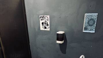 A bathroom with a toilet, sink, and trash bin.