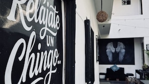 A building with a sign that reads 'Relajate Un Chingo.'