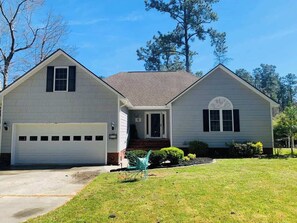A two-story house with a garage, a front porch, and a well-maintained lawn. - Sirena's Isle Waterfront
boat lift, pet friendly (Oriental)