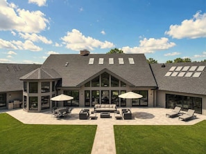 A modern house with a large patio area, outdoor furniture, and a covered seating area. - Fauzan, a Private Residential Resort (Wall Township)