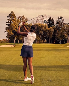 A person playing golf on a course with trees in the background. - Fauzan, a Private Residential Resort (Wall Township)