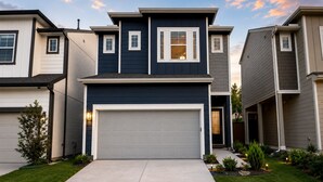 A modern two-story house with a garage, a well-maintained lawn, and a clear sky. - Luxe Haven Stays Spacious 3BR Near NRG, Med Center & Downtown Houston (Houston)