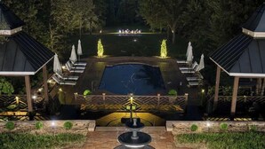 A landscaped outdoor area with a central fountain, seating areas, and a pool. - Private 16-Acre Lakefront Manor | Pool | Sleeps 14 (Culpeper)