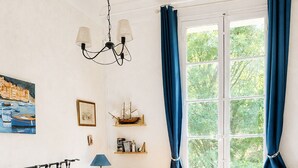 A neatly arranged bedroom with a bed, desk, chair, and a view of greenery through the window. - Large villa very close to Aix-en-Provence (Aix-en-Provence)