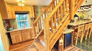 A wooden staircase leading to a dining area with a view of the kitchen. - Mountain Views ,Sunsets, Jacuzzi spa , Kayak to waterfalls,5 mins to Beaver lake (Eureka Springs)