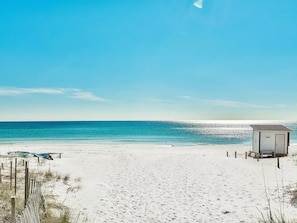A beach with a small wooden structure, likely a lifeguard station, and a sandy path leading to the water. - Bougie Beach Home: 3BR-sleeps 10-Golf Cart, 4 E-Scooters, PS5, BunkRoom, Tesla🔌 (Destin)