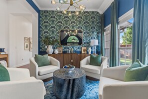 A living room with two white sofas, a round coffee table, and a patterned rug. - POOL , MINI GOLF & OUTDOOR MOVIE THEATER (McKinney)