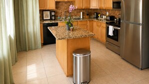A modern kitchen with wooden cabinets, a stainless steel refrigerator, and a granite countertop. - Walk to Old Town • Pool • Golf • Sleeps 10 (Scottsdale)
