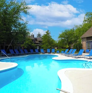 A swimming pool with blue chairs and trees around it. - 1 B/1 BA fully furnished unit in luxury apartment community/ Indianapolis/ 46260 (Indianapolis)