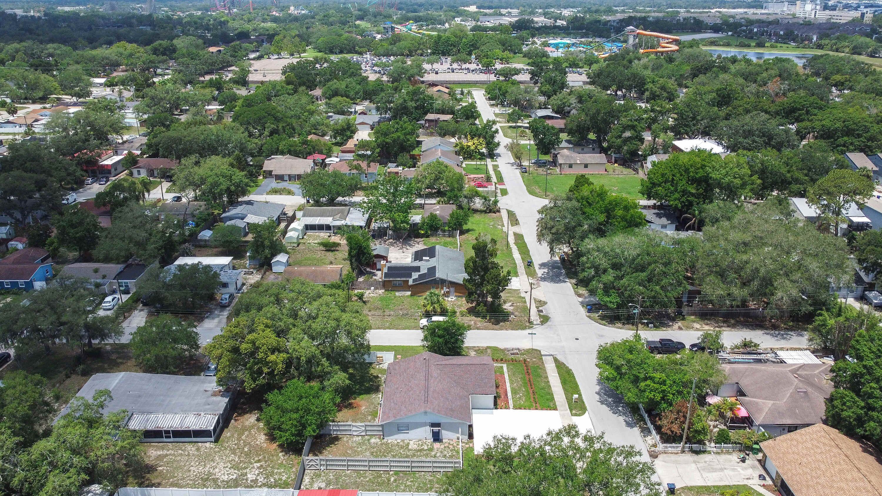 A residential area with houses, streets, and a park.