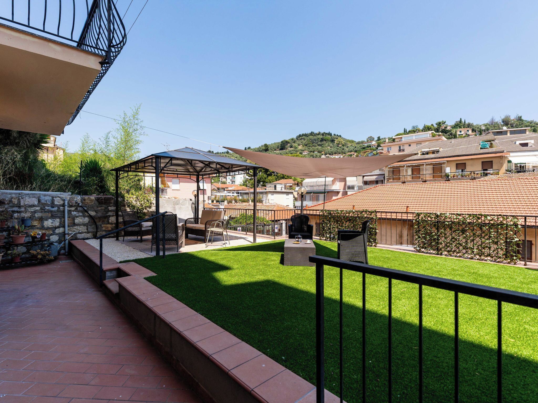 A courtyard with a patio area, outdoor furniture, and a pergola.