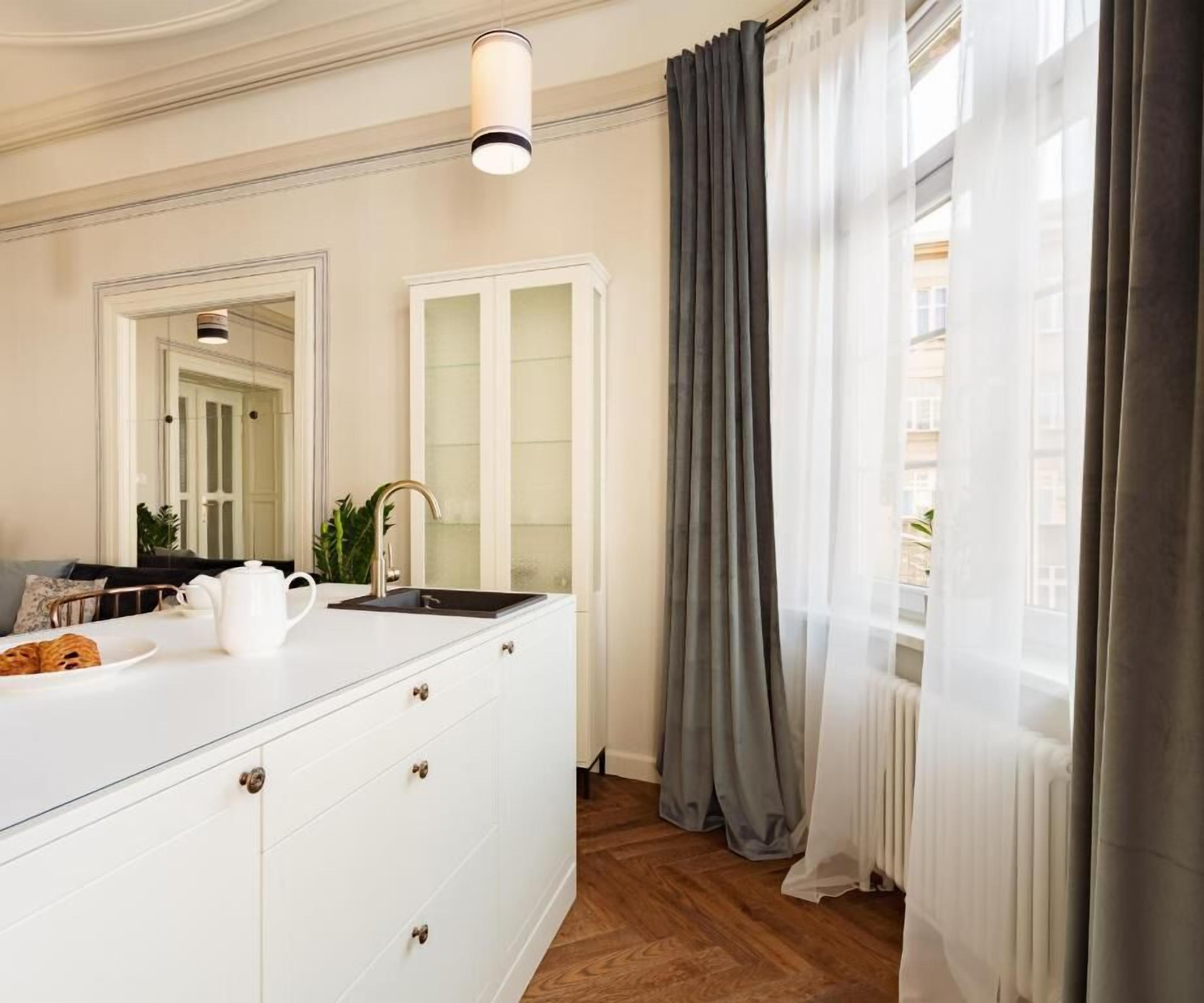 Een moderne badkamer met een witte wastafel, een spiegel, een wastafel en een douchehoek.