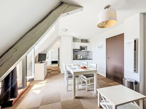 A modern kitchen with white cabinets, a microwave, and a coffee machine. - Le Château de Kergonano by Interhome (Baden)