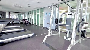 A gym with treadmills, weight machines, and stationary bikes.