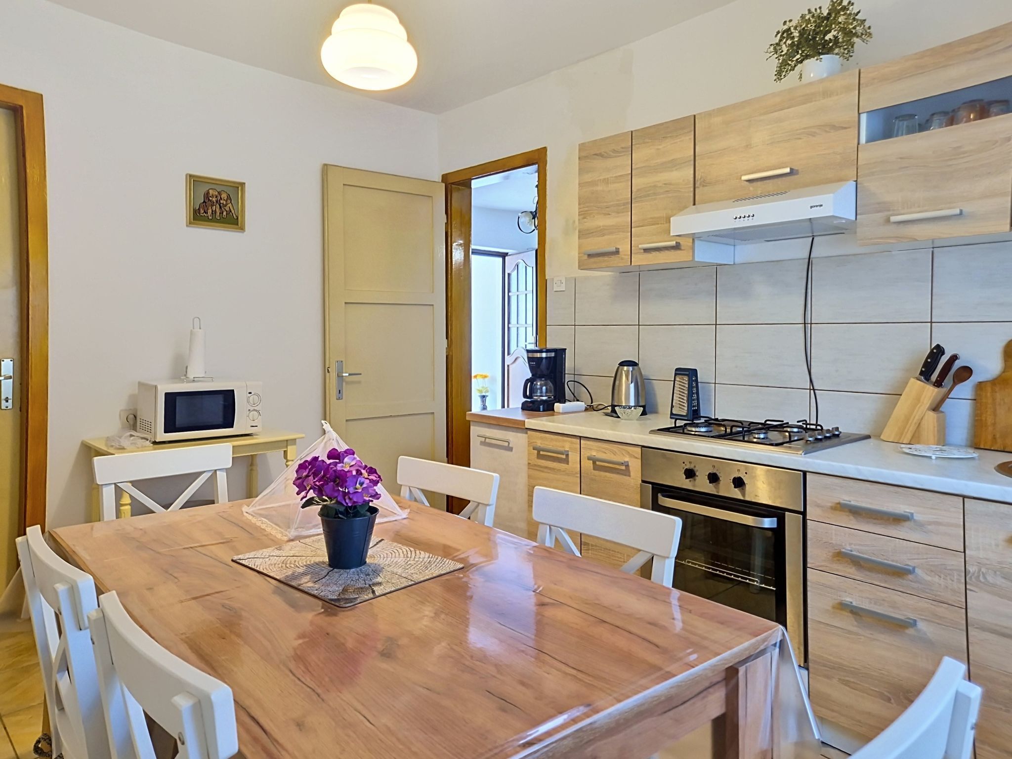 A kitchen with wooden cabinets, a stove, and a microwave.