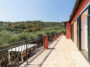A balcony with a metal railing overlooking a hilly landscape. - Orto di Silvia by Interhome (Torrazza)