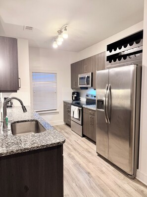 Fridge, microwave, oven, stovetop - Luxe 2BR Apartment in Cypress, TX w/Corner Balcony. Prime for Shopping & Dining! (Cypress)