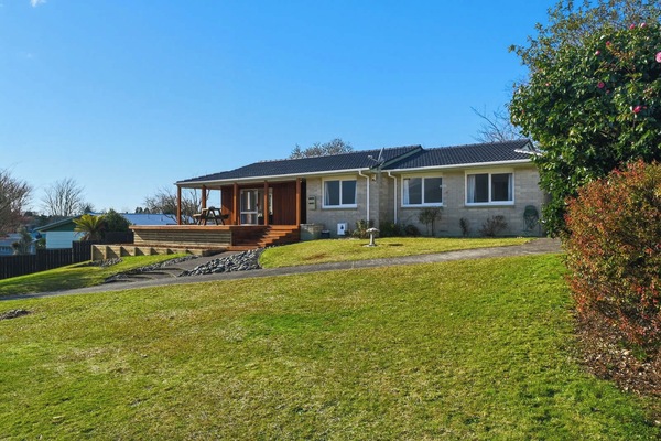 Brick home with covered front deck