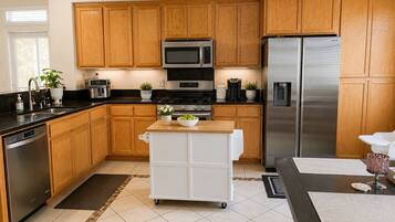 Fridge, microwave, coffee/tea maker, cookware/dishes/utensils