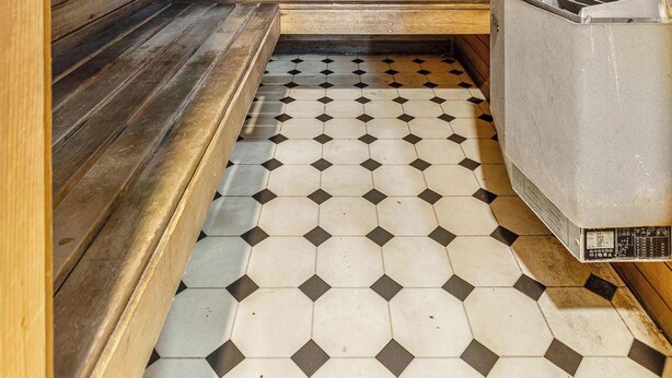 A sauna with wooden walls and a tiled floor. - Stylish studio apartment opposite Carlton Gardens (Carlton)