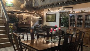 A dining area with a wooden table, chairs, and a chandelier.