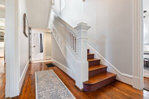 A staircase with white balusters and a wooden handrail leading to an upper floor. - Adorable 4-3 close to EVERYTHING! (Birmingham)