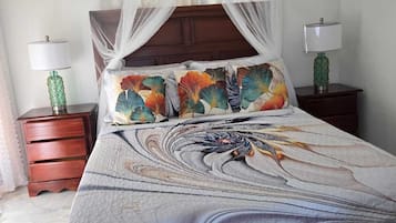 A bed with a canopy, a nightstand with a lamp, and a bedside table with a lamp.