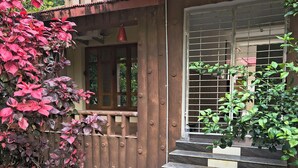 A staircase leading to a wooden door, surrounded by plants and a railing. - Dioza Eco Resort (Gop)