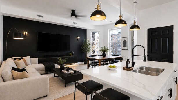 Ett modernt vardagsrum med en soffa, ett soffbord och en tv, en matplats med ett bord och stolar samt ett kök med en diskho och en bänkskiva.
