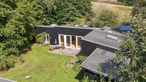 A modern house with a large garden, a patio with outdoor furniture, and a garage. - "Verna" - 450m from the sea by Interhome (Ebeltoft)