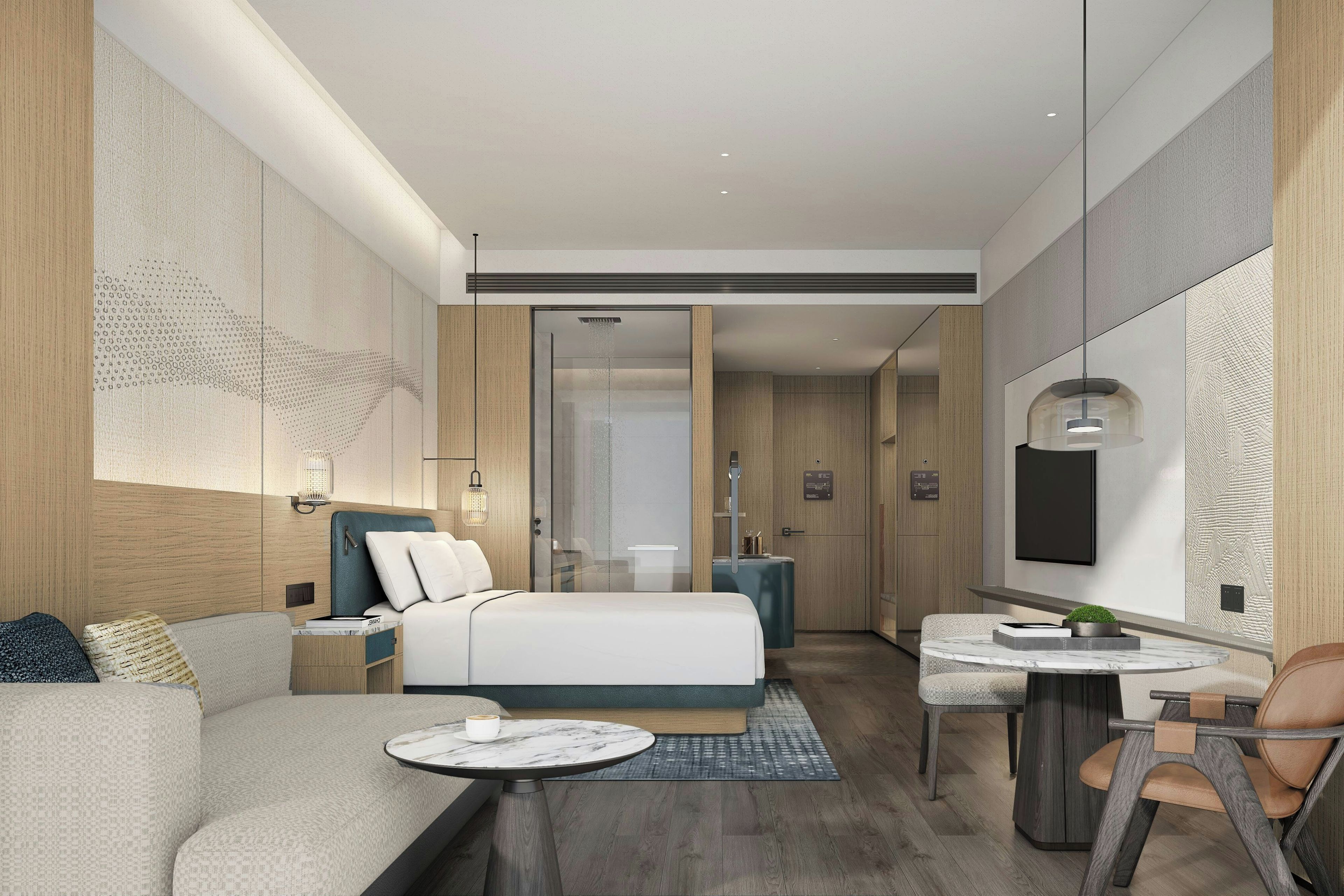 A modern hotel room with a bed, seating area, and a small table.