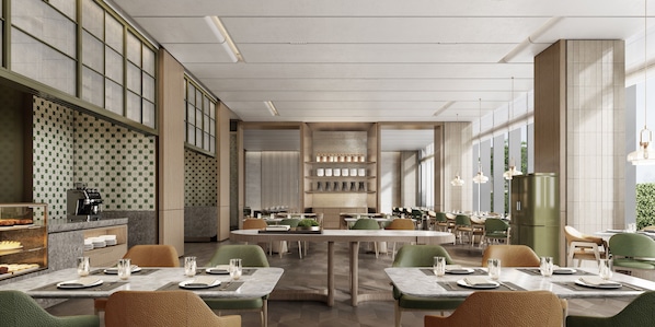 Un restaurante moderno con techos altos, amplias ventanas y diversas opciones de mesas.