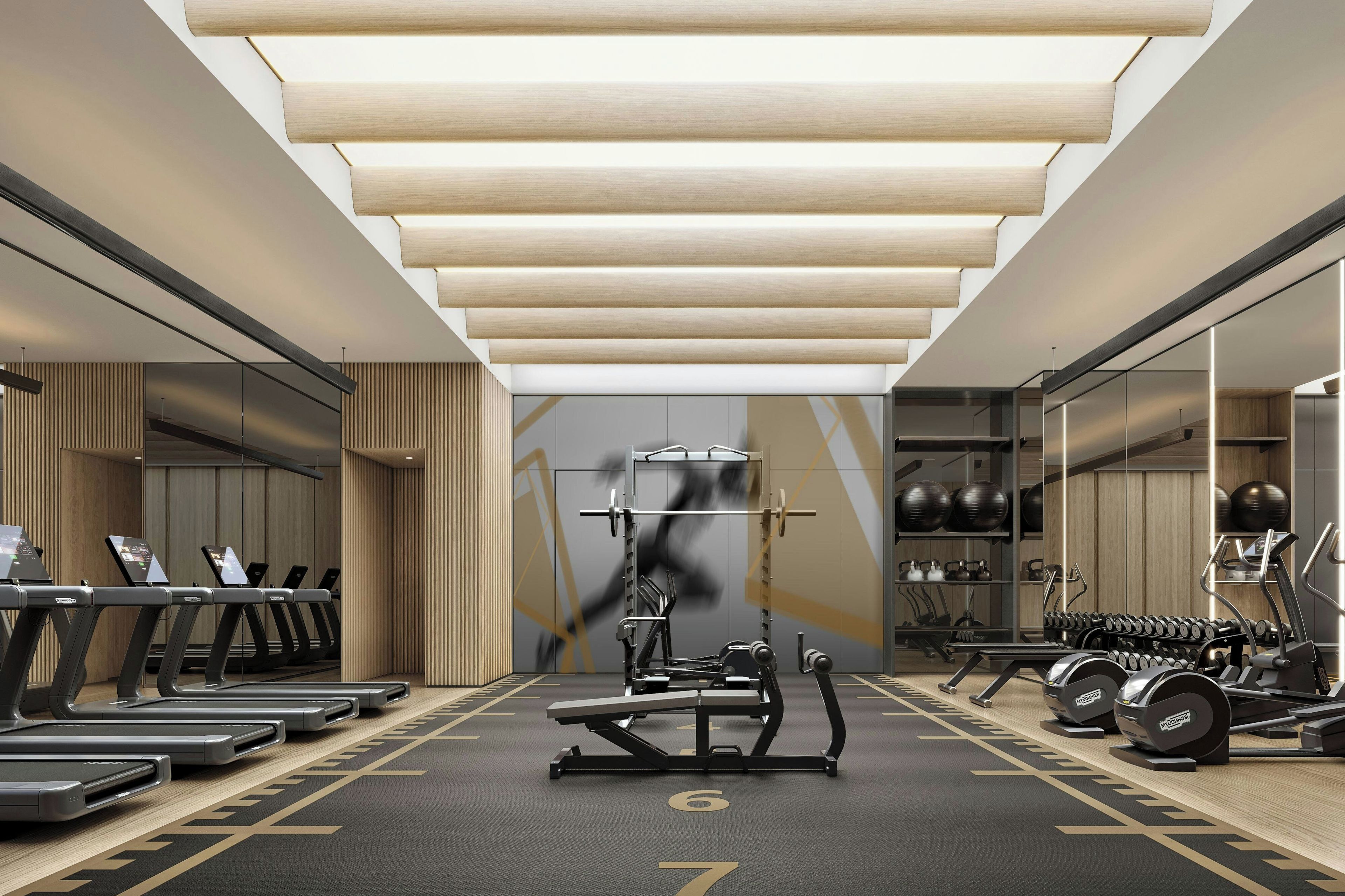Un gimnasio moderno con cintas de correr, máquinas de pesas y pesas sueltas.