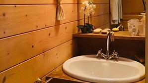 A wooden bathroom with a sink, mirror, and towel rack. - Unusual caravan, sunset with vineyards in the Ain valley (SAINT-ALBAN)