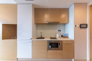 A modern kitchen with a built-in oven, a sink, and a stove.