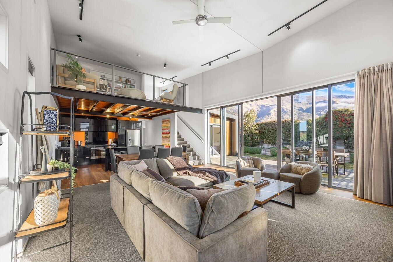 Spacious sunny lounge looking up to mezzanine