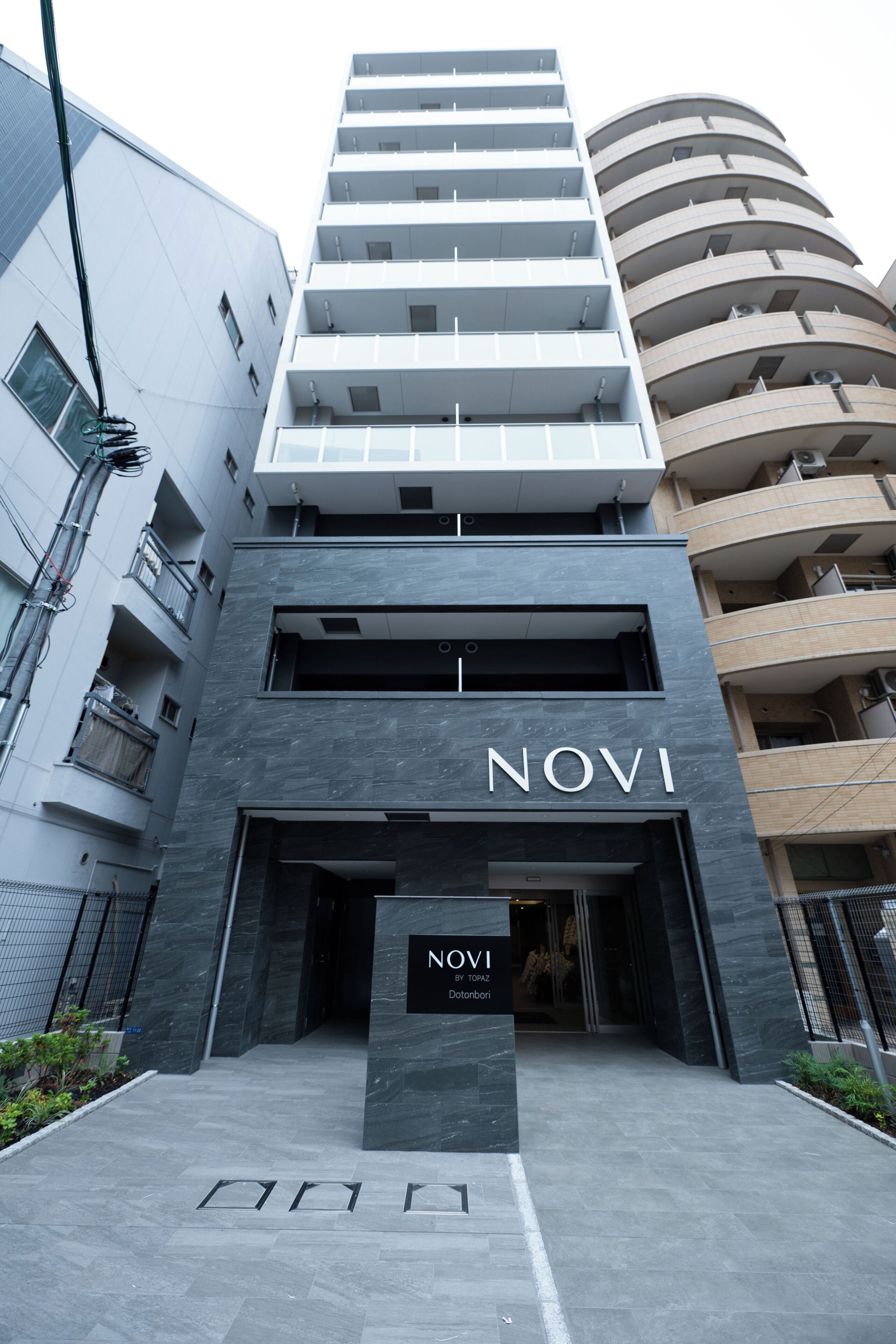 A modern building with a prominent 'NOVI' sign at the entrance.