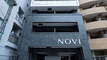 A modern building with a prominent 'NOVI' sign at the entrance.