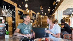 A bar area with wooden walls, star decorations, and a menu board. - T-Resort by Interhome (La Tzoumaz)