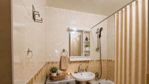 A bathroom with a washing machine, sink, and bathtub. - Nice hostel in Mongolia (Ulaanbaatar)