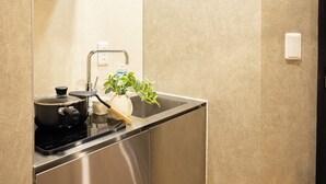 A modern kitchen with stainless steel appliances, a sink, and a potted plant. - A 5-minute walk from Yoyogi Station on the JR Yamanote Line; an apartment for 3 people (渋谷区)