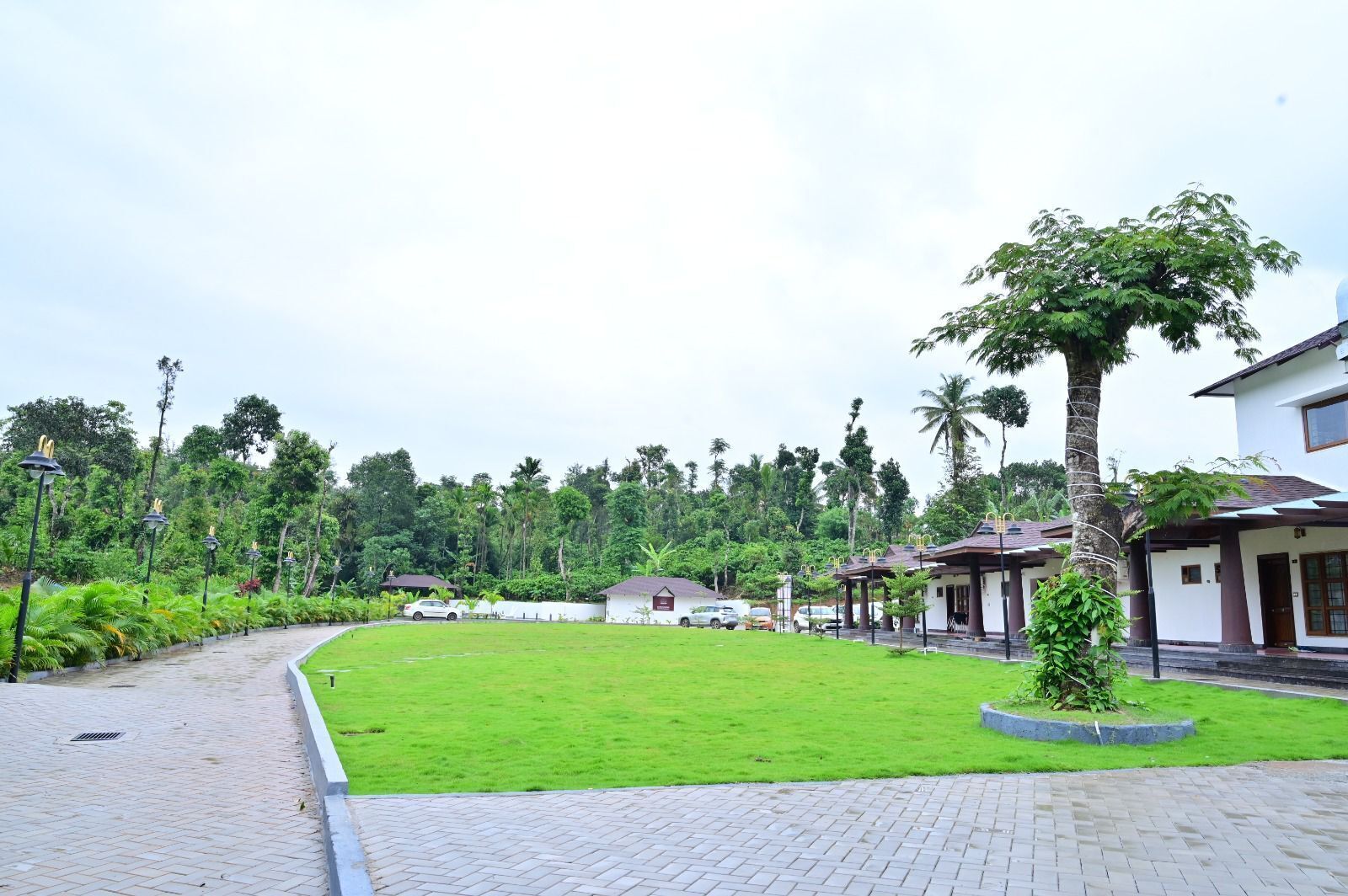 A well-maintained lawn, a paved walkway, and a row of buildings with a consistent architectural style.