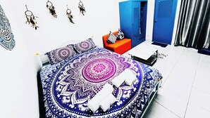 A bedroom with a bed, a red chair, a blue wardrobe, and a door. - 208 Budget Room Wi-Fi &Utilities Bangkok’s center (Bangkok)