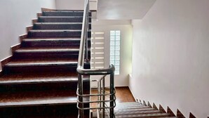 A staircase with a metal handrail leading to a landing. - 307 Budget Room, wifi&utilities Bangkok’s center (Bangkok)