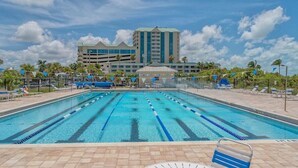 A swimming pool with lane dividers, lounge chairs, and a building in the background. - 1R Lido Key - Steps to Beach, Walk to St. Armand's (Sarasota)