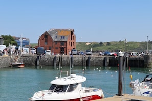 A marina with boats docked, a red brick building, and a clear sky. - 2 Red Brick Building - central Padstow with beautiful estuary  & harbour views (Padstow)