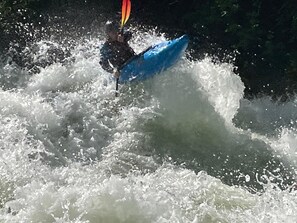A person kayaking in a turbulent water body. - Hungry Horse Hideout - Lower Level (Hungry Horse)