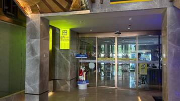 A 24-hour convenience store with a marble floor and glass entrance doors.